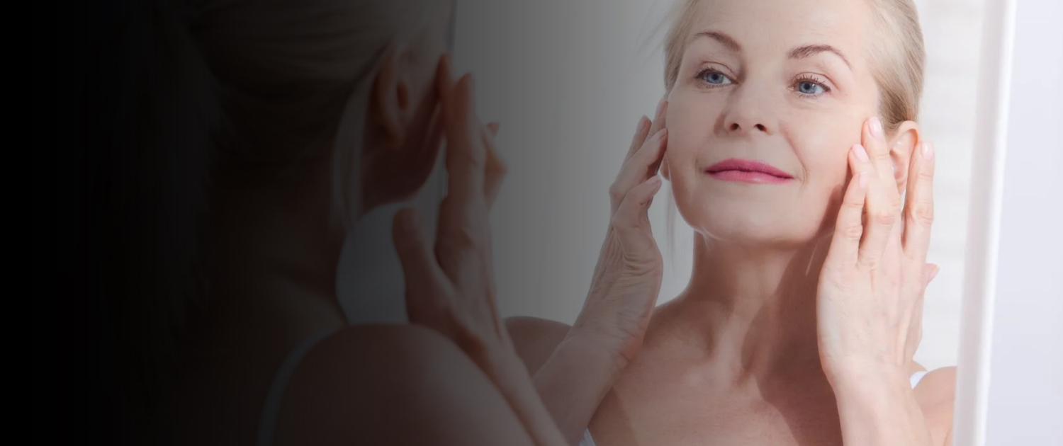 Woman examining her skin in mirror