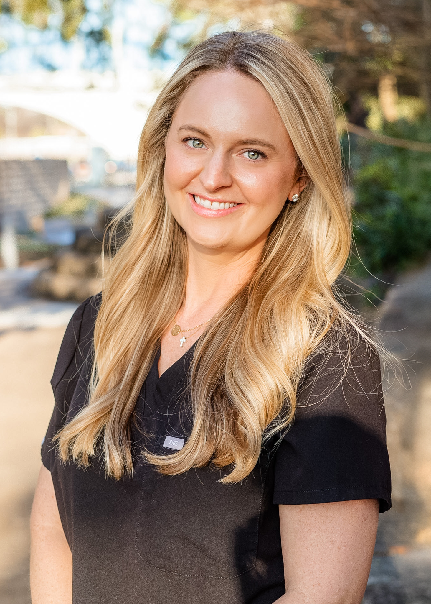 Smiling woman in professional attire.