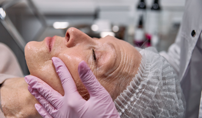A board-certified dermatologist conducting a professional medical skin evaluation on an adult patient's face at Chattanooga Skin and Cancer Clinic.