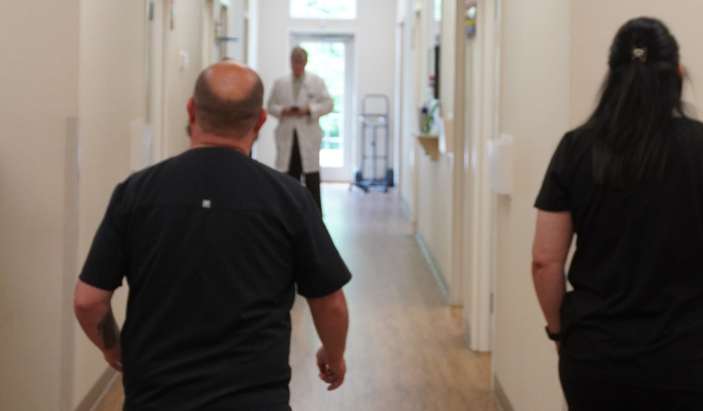 Medical staff and dermatologist walking down the hallway of Chattanooga Skin and Cancer Clinic, a premier dermatology clinic.