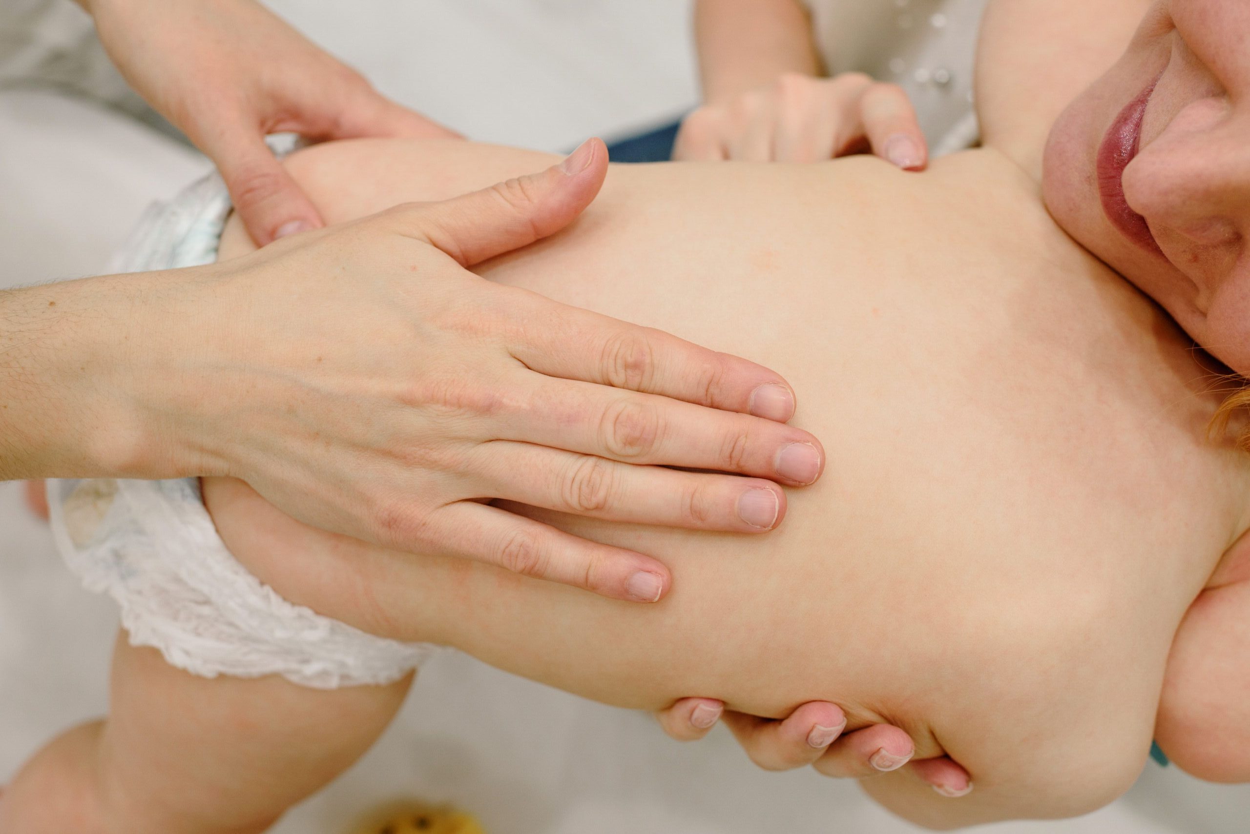 A parent checking a baby's back for dry patches and toddler eczema flares in Chattanooga.