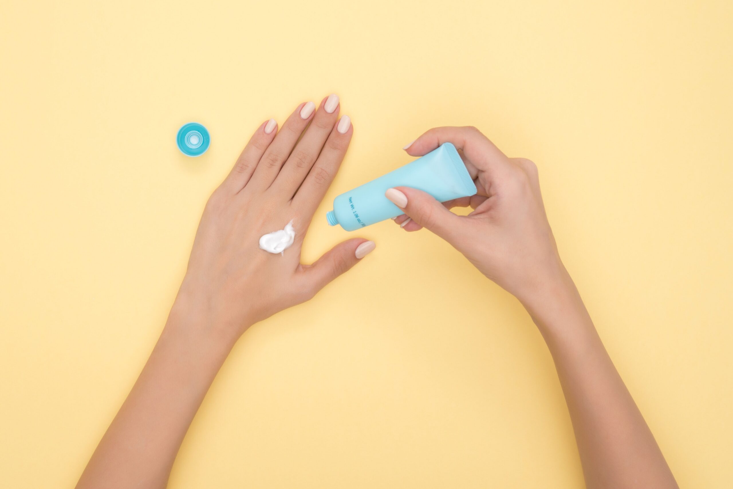 Sunscreen squeezed onto hand showing proper amount to avoid sunscreen application mistakes