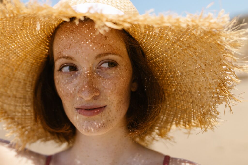 Woman wearing a wide-brimmed straw hat to protect her face from the sun