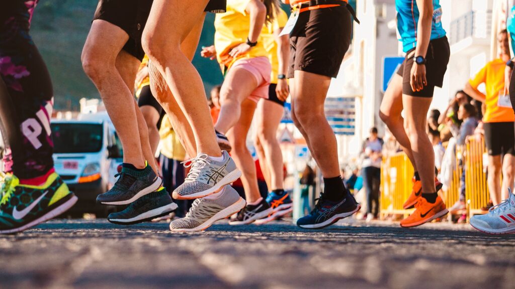 Runners in athletic shoes practicing fungal skin infection prevention in Chattanooga during a road race