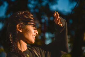 Woman shielding her face from the sun outdoors during early fall in Chattanooga TN