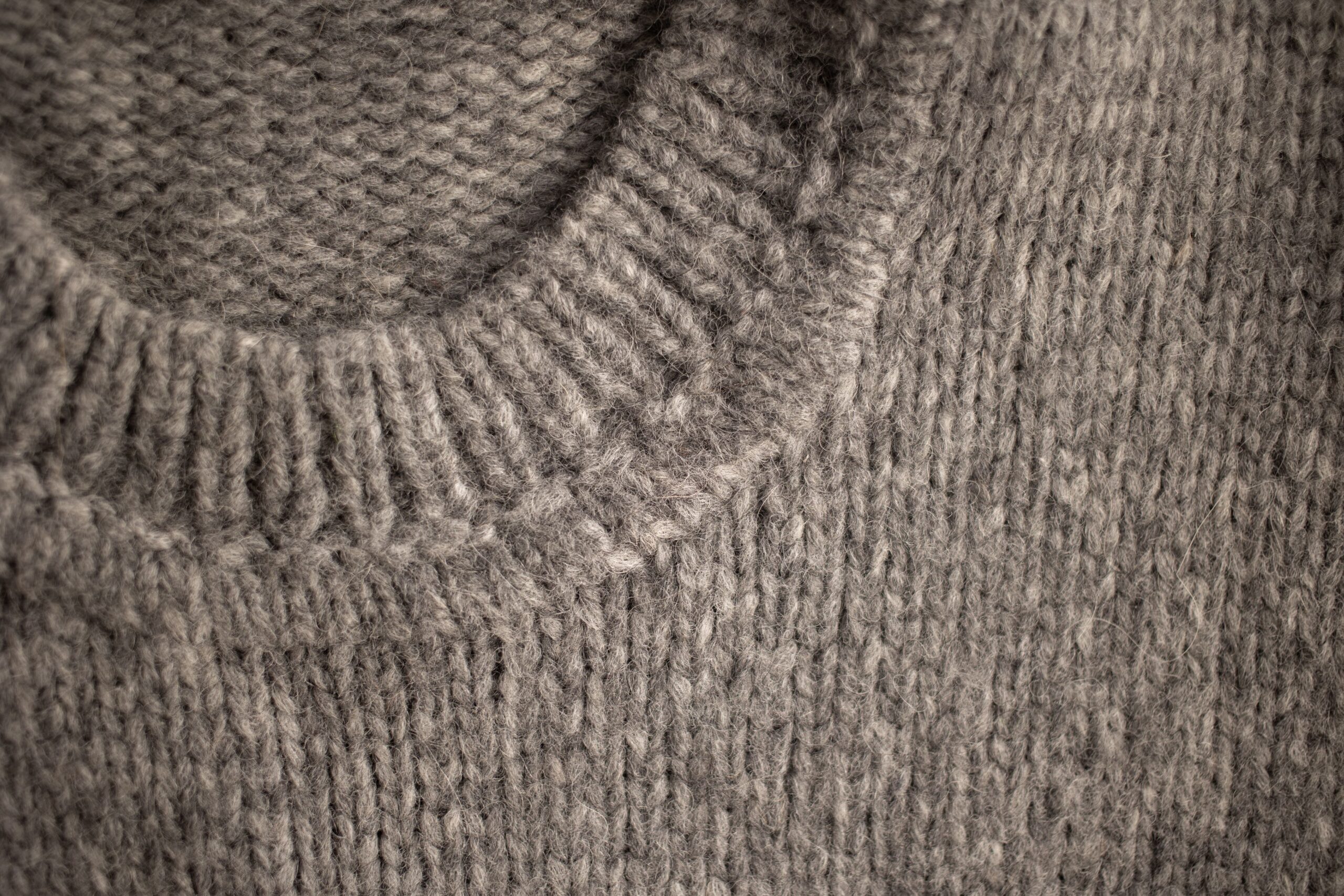 Close-up of rough wool sweater fabric that can irritate eczema in fall